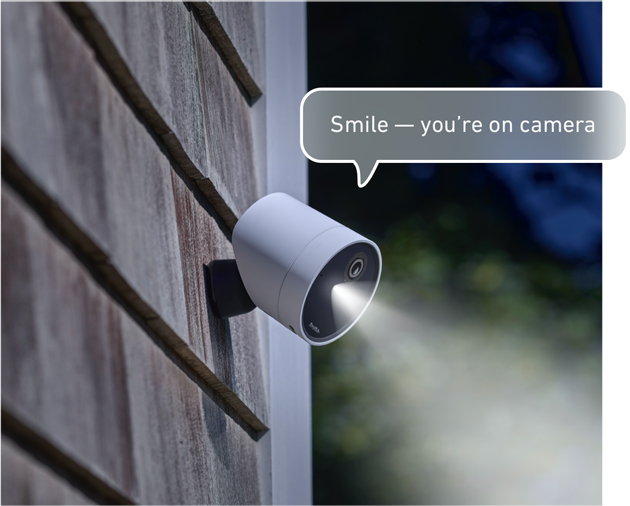 outdoor security camera with caption saying smile you're on camera